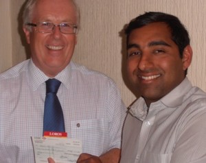 Adrian Walker reeivees a cheque from Dipan Bhagalia