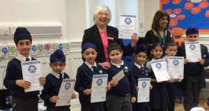 Pam Spokes and Jasbir Mann with the Falcons School winners. Overall winner Marian Bendik in front of Pam