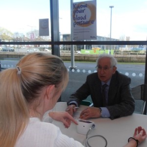 Prof Bert Thurston records the blood pressure of a shopper during Rotary's Know Your Blood Pressure event at Asda, Abbey Lane Leicester