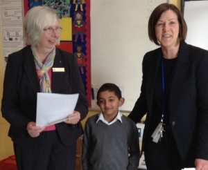 Neil Patel, winner of a £5 voucher and his certificate presented by Pam Spokes (left)