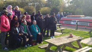 The passengers pose for a group photo while the boat crew take a lunch break