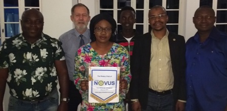 Rotary Club of Brusubi member Fatoumata with the Novus banner flanked by Rotarians Cornelius, Martin and Michael. Behind them is visiting businessman Christian Jorgensen and student Mbuba