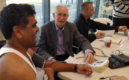 A shopper has his blood pressure measured by Prof Bert Thurston, a member of the Rotary Club of Leicester Novus