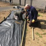 Laying the membrane to keep the new path weed-free