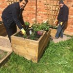 Pradeep and Frazer pause from planting