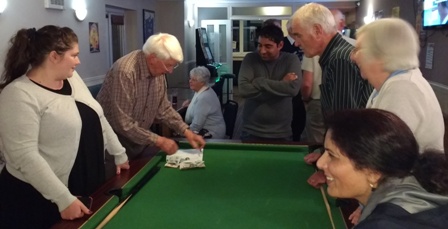 Gemma Kiddy and Alan Grundy tot up the scores, eagerly watched by members of both clubs