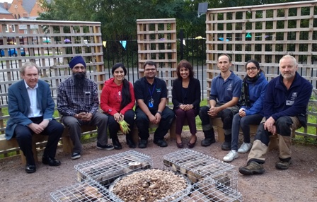 Volunteers with the newly-installed water feature at the Falcons Peace Garden 