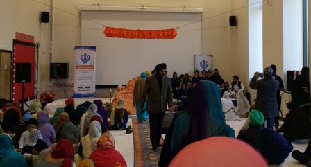 Children singing in the school hall alongside the holy Guru Granth Sahib. Please click on the photo and turn your volume up