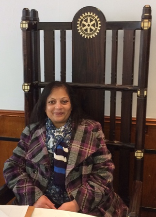 Sarita Shah sits in the ornamented chair of the President of the Rotary Club of Leicester