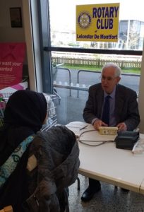 Bert Thurston gives advice to a shopper after he had taken her blood pressure