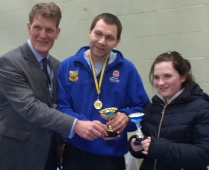 Richard Smith, bursar of Stamford Endowed Schools, presents the trophies to men's darts champion Andrew Chomyn and women's champion Nadeen Heywood