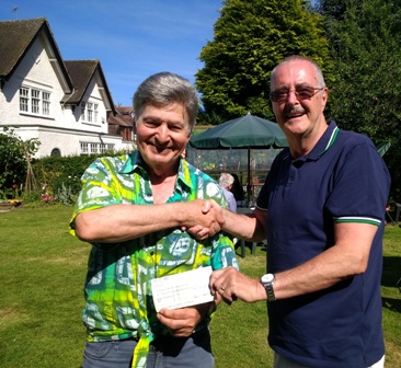 Novus member Jim Matthews (right) presents a cheque for £1637.33 to Rotarian Roger Neuberg for the Rotary Club of Oadby Jaipur Limb appeal