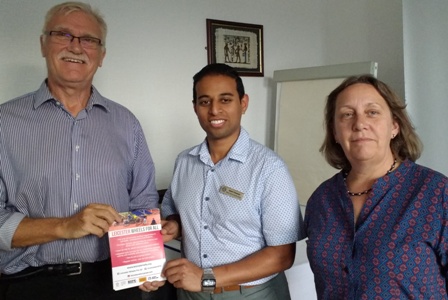 Wheels For All chairman Peter Simmonds and secretary Linda Goddard present fliers to Rotary president Jason Chauhan