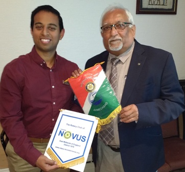 Bannerman times two. President Jason Chuhan exchanges banners with Rotarian Vasant Kalyani