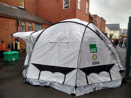 A Shelterbox tent like this can be a temporary home for a family made homeless by a disaster. This one was a gateway to the assembly hall at Falcons Primary School