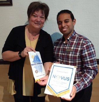 President Jason Chauhan and District Governor Elect Louisa Horne, from Halifax, Nova Scotia, exchange banners