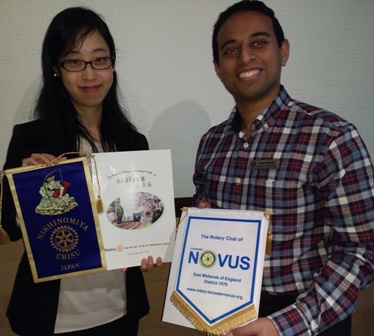 Rotary sponsored scholar Mai Tsumura and President Jason Chauhan with banners