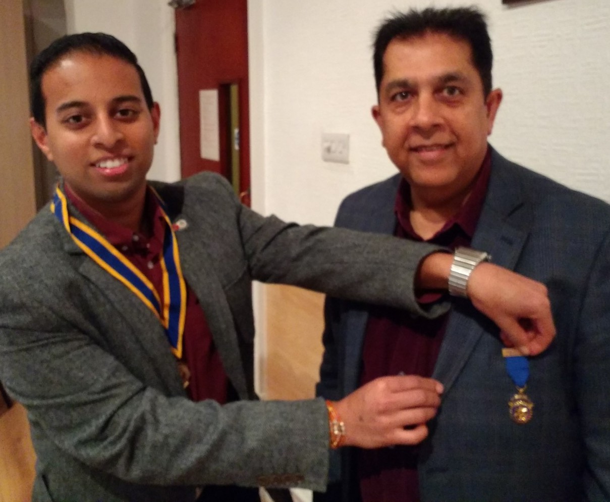 Out with the old. Pradeep Popat receives his past president's badge from Jason Chauhan