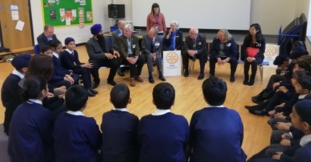 Members of the school council discuss the benefits of the Peace Garden with visting Rotarians. In the background is staff member Emily York who took part in Rotary's Youth Leadership Award scheme