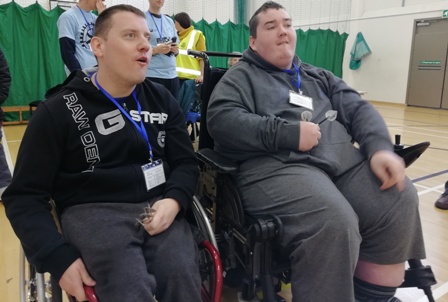 Scott Keating and Calum Smith sit side by side in an early round of the men's darts competition.