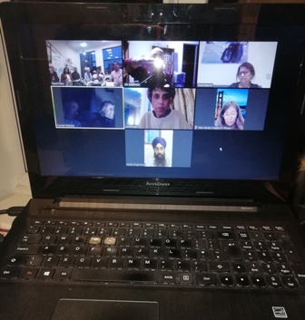 Seven screens with 15 members attending the club's first online meeting